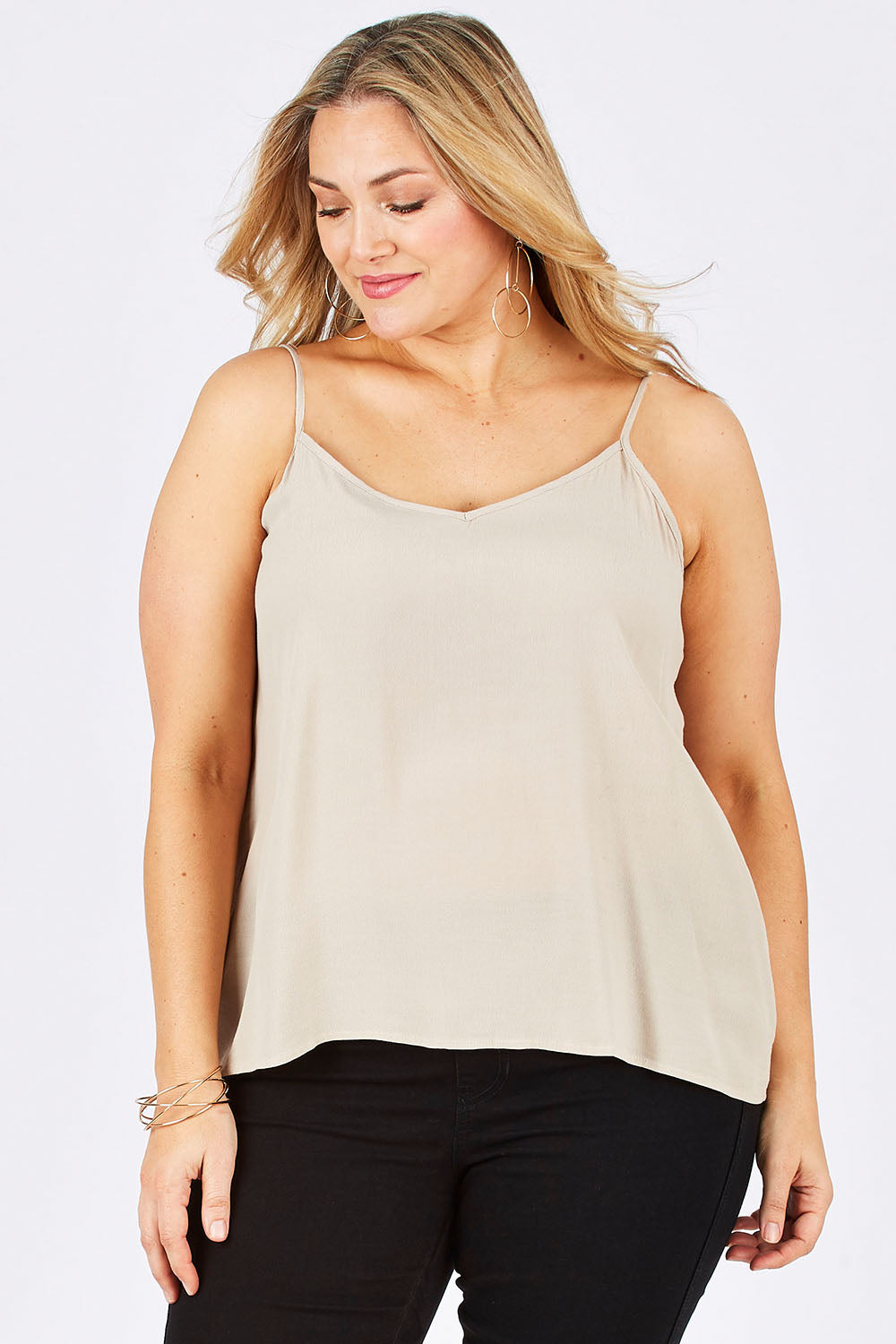Model Ljubenka wearing size 18 of the Runaway Top in colour Sand, from the front, cropped image
