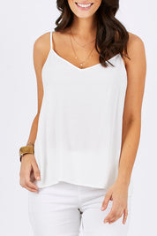Model Georgia wearing size 10 of the Runaway Top in colour White (White), from the front, cropped image