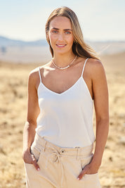 Model Tegan wearing size 10 of the Runaway Top in colour White (White), from the front, cropped image