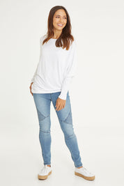 Model Cara wearing the Wild Plains Stitched Jeggings in colour MidDenim (Blue), from the front, showing the whole outfit