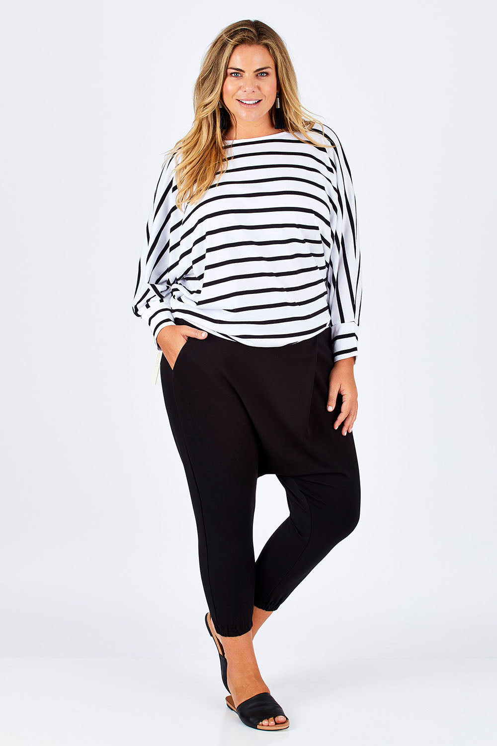 Model Fiona wearing size 16 of the Relax With Me Pants in colour Black (Black), from the front, showing the whole outfit