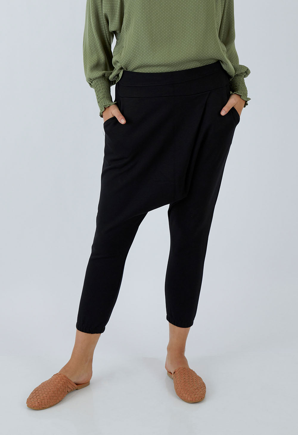 Model Madeline wearing size 10 of the Relax With Me Pants in colour Black (Black), from the front, cropped image