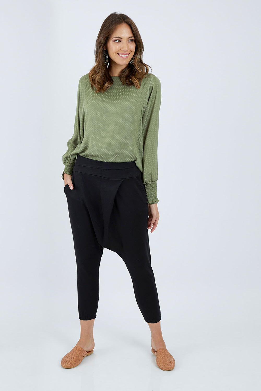 Model Madeline wearing size 10 of the Relax With Me Pants in colour Black (Black), from the front, showing the whole outfit