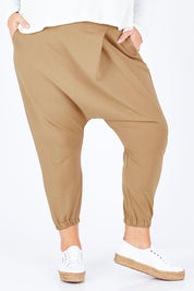 Model Sophie wearing size 18 of the Relax With Me Pants in colour Tobacco, from the front, cropped image