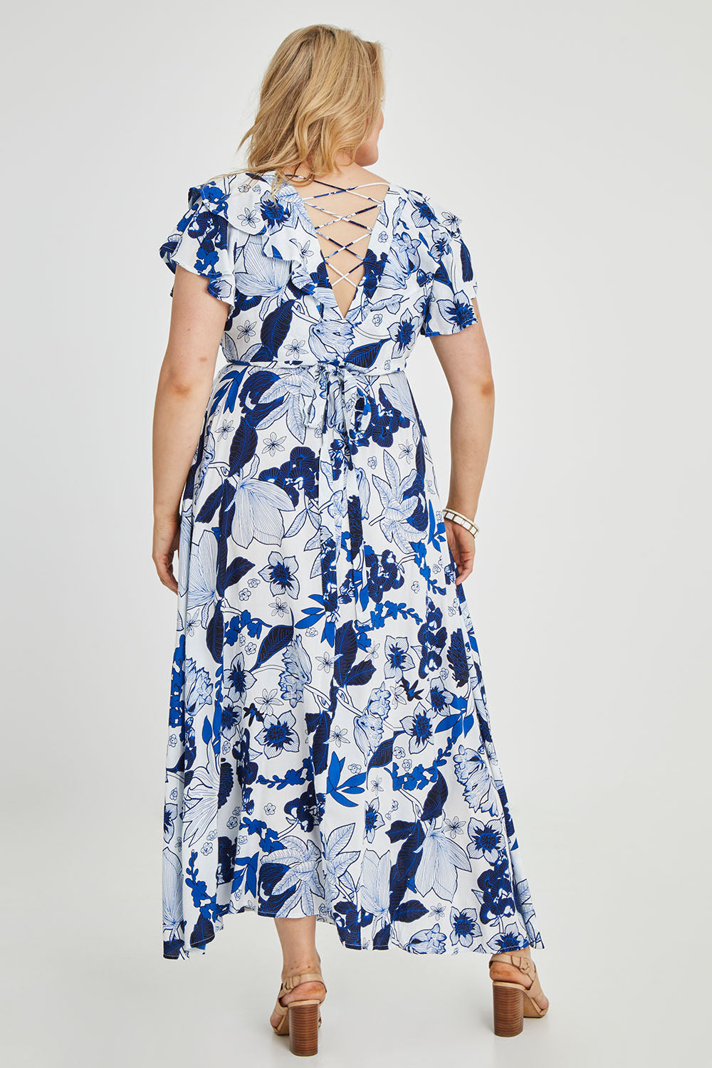 Model Keeara wearing size 16 of the Bellezza Maxi Dress in colour Blues (Blue), from the back