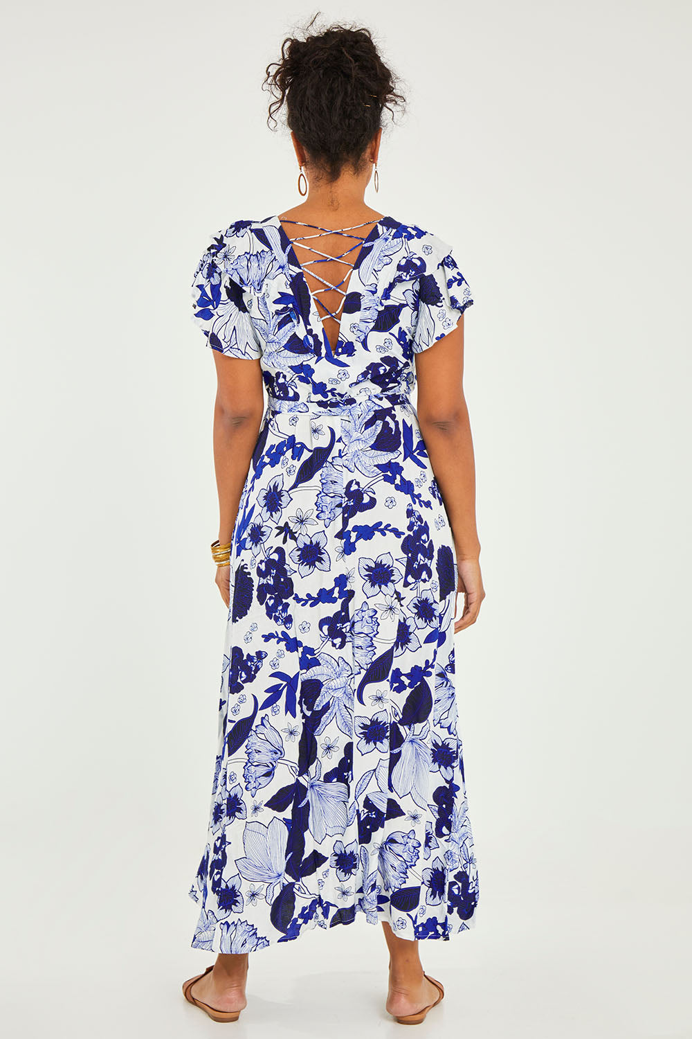 Model Noli wearing size 14 of the Bellezza Maxi Dress in colour Blues (Blue), from the back