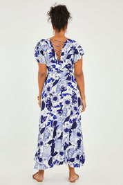 Model Noli wearing size 14 of the Bellezza Maxi Dress in colour Blues (Blue), from the back