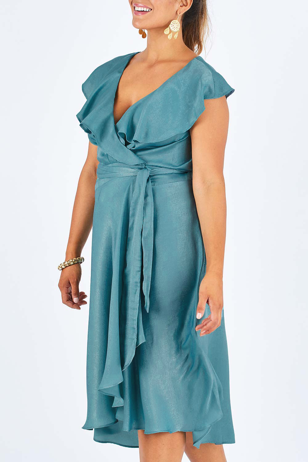 Model Palatina wearing size 14 of the Amore Wrap Dress in colour Teal (Green), from the front, cropped image