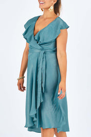 Model Palatina wearing size 14 of the Amore Wrap Dress in colour Teal (Green), from the front, cropped image