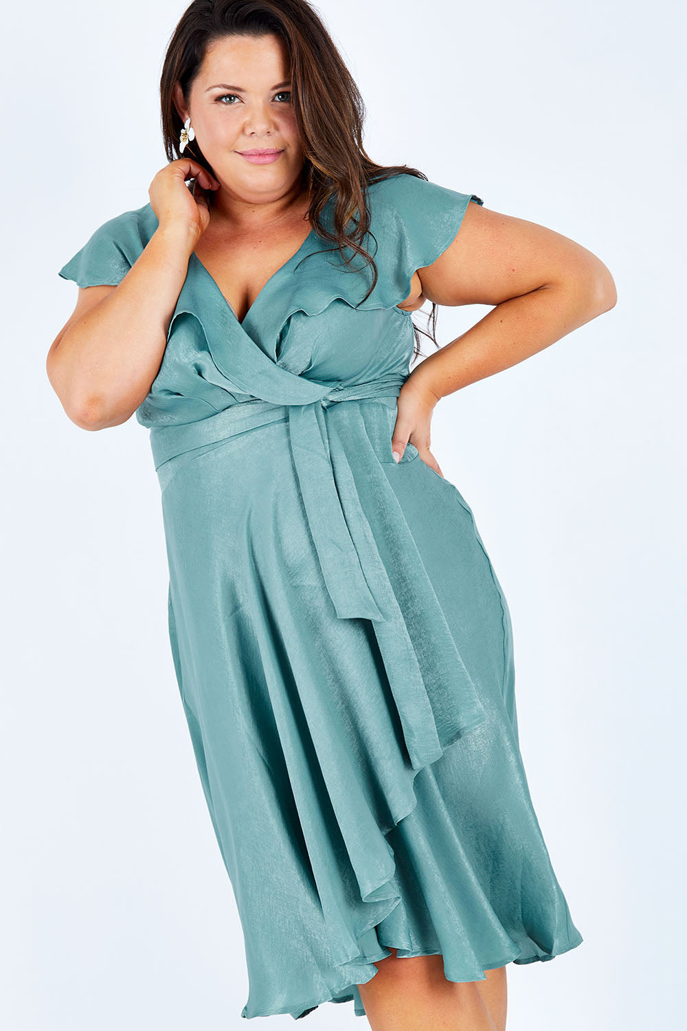 Model Stacey wearing size 16 of the Amore Wrap Dress in colour Teal (Green), from the front, cropped image