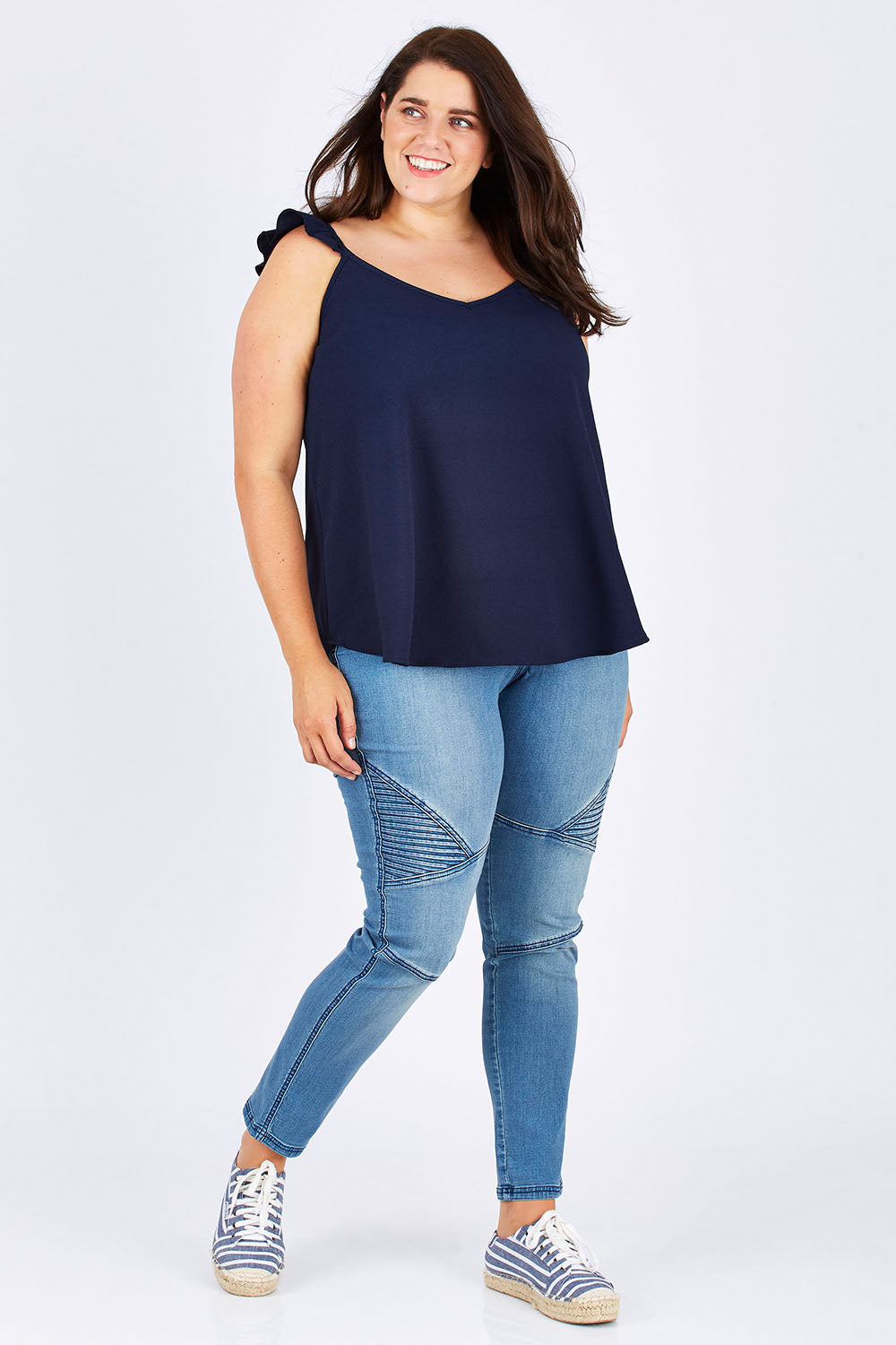 Model Mae wearing size 18 of the Romance All Around Top in colour Navy (Blue), from the front, showing the whole outfit