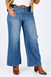 Model Fiona wearing size 16 of the Happy Me Wide Leg Jeans in colour Denim (Blue), from the front, cropped image