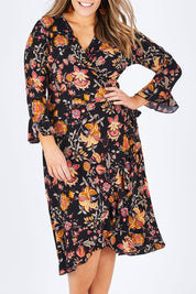 Model Natalia wearing size 14 of the Swanning Around Wrap Dress in colour BlackOrch (Black), from the front, cropped image