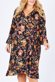 Model Sophie wearing size 18 of the Swanning Around Wrap Dress in colour BlackOrch (Black), from the front, cropped image