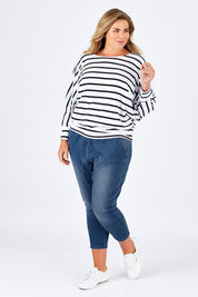 Model Fiona wearing size 16 of the Just Chillin Stretch Dropped Crotch Jeans in colour Denim (Blue), from the front, showing the whole outfit