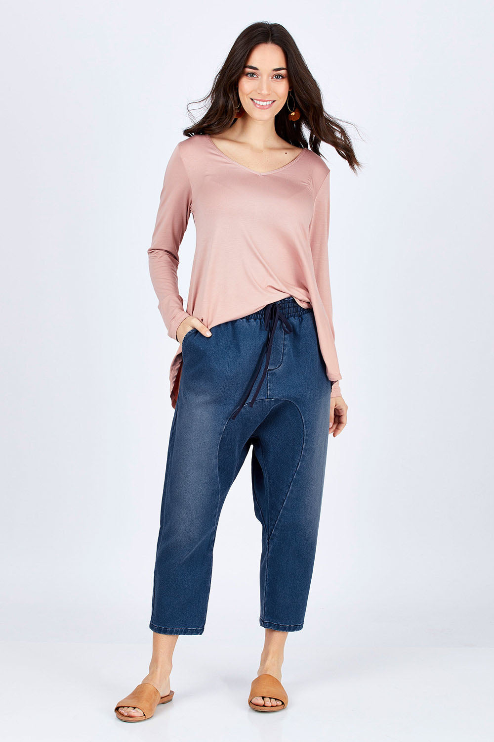 Model Georgia wearing size 10 of the Just Chillin Stretch Dropped Crotch Jeans in colour Denim (Blue), from the front, showing the whole outfit