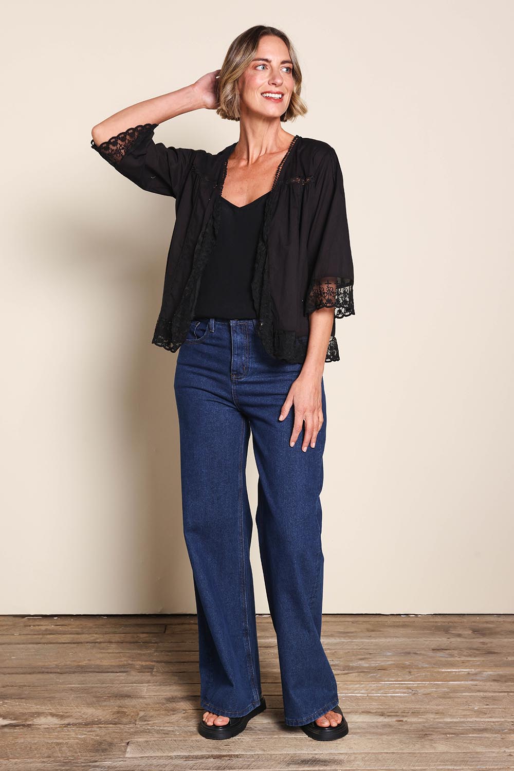 Model Riinar wearing size 10 of the Spring Day Cotton Throw - Black in colour Black, from the front