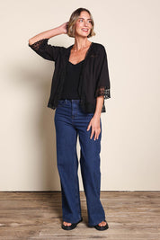 Model Riinar wearing size 10 of the Spring Day Cotton Throw - Black in colour Black, from the front
