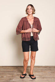 Model Riinar wearing size 10 of the Spring Day Throw – Chocolate in colour Chocolate, from the front