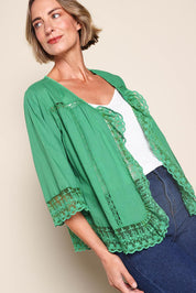 Model Riinar wearing size 10 of the Spring Day Cotton Throw – Green in colour Green, from an angle