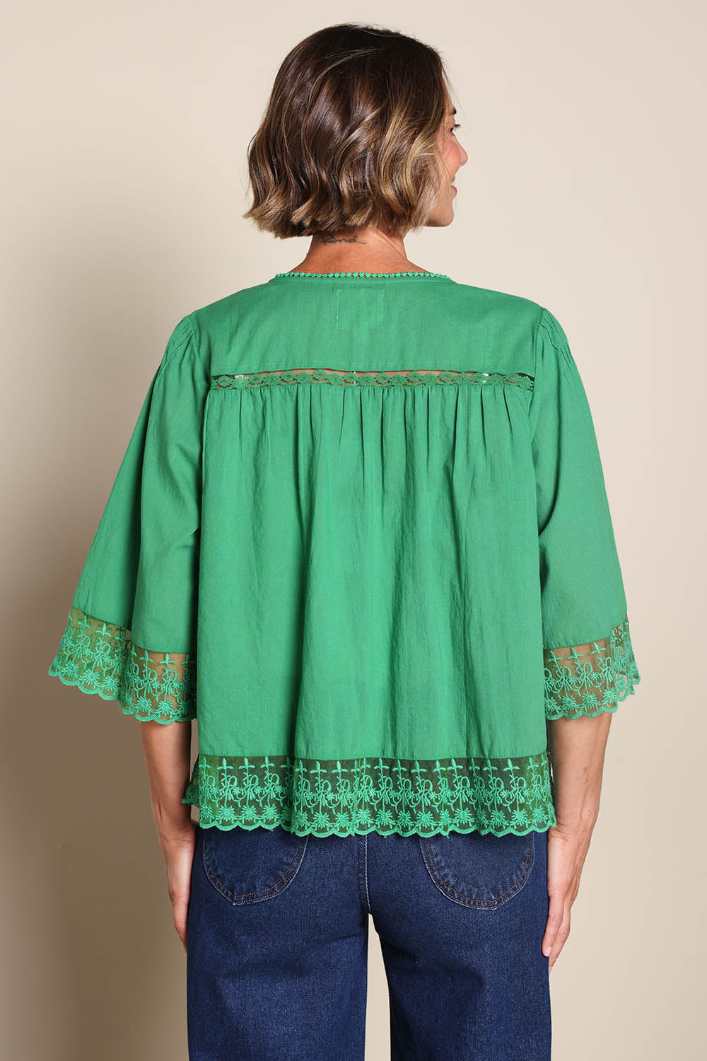 Model Riinar wearing size 10 of the Spring Day Cotton Throw – Green in colour Green, from the back