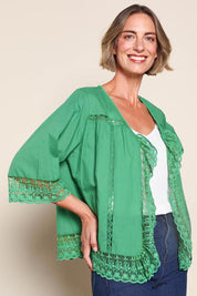 Model Riinar wearing size 10 of the Spring Day Cotton Throw – Green in colour Green, in a cropped view