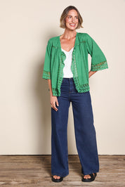 Model Riinar wearing size 10 of the Spring Day Cotton Throw – Green in colour Green, from the front