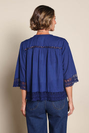 Model Riinar wearing size 10 of the Spring Day Throw – Navy in colour Navy, from the back
