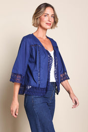 Model Riinar wearing size 10 of the Spring Day Throw – Navy in colour Navy, in a cropped view