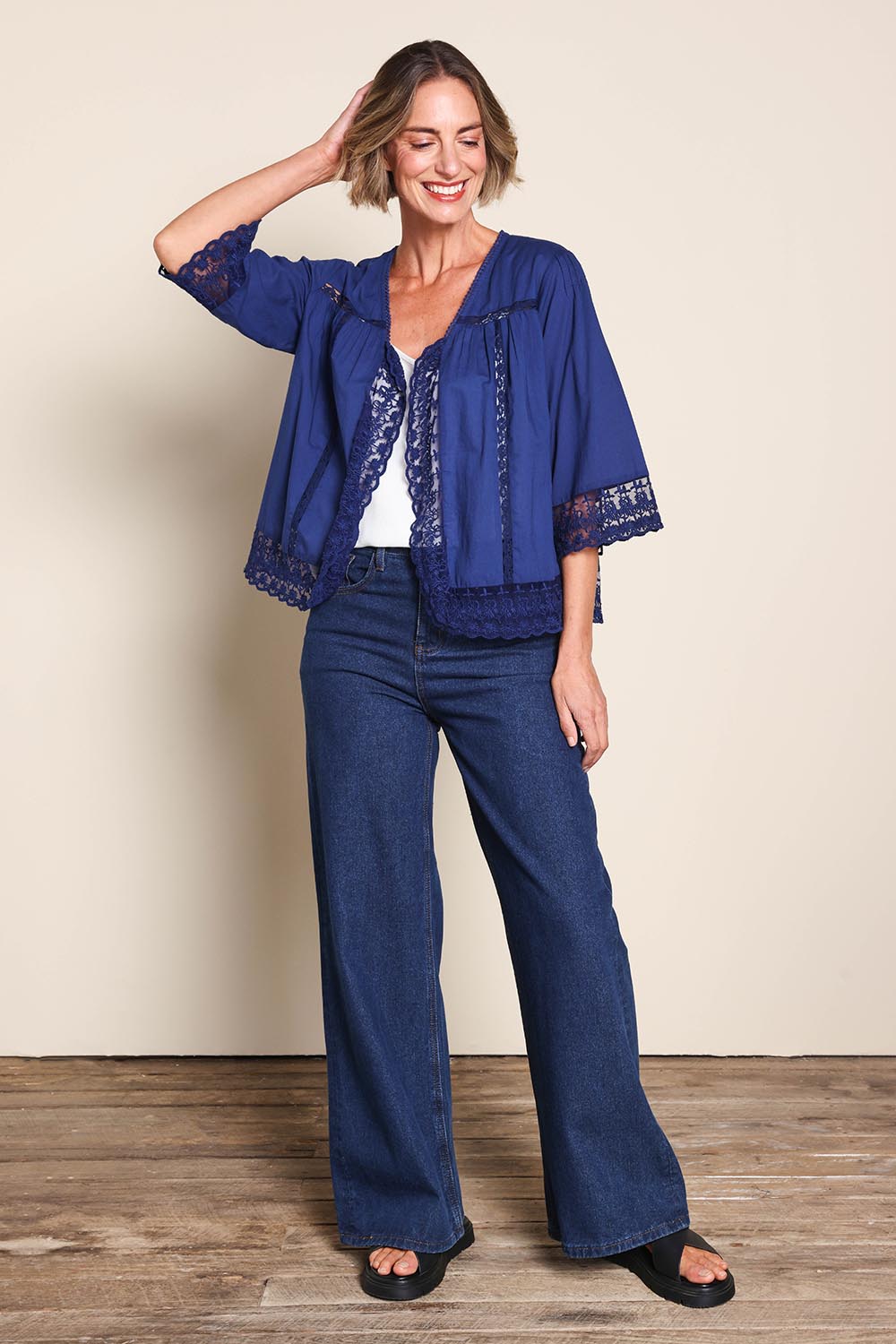 Model Riinar wearing size 10 of the Spring Day Throw – Navy in colour Navy, from the front