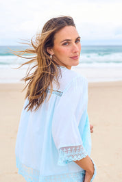 Model Tegan wearing size 10 of the Spring Day Cotton Throw in colour Sky (Blue), from the front, showing the whole outfit