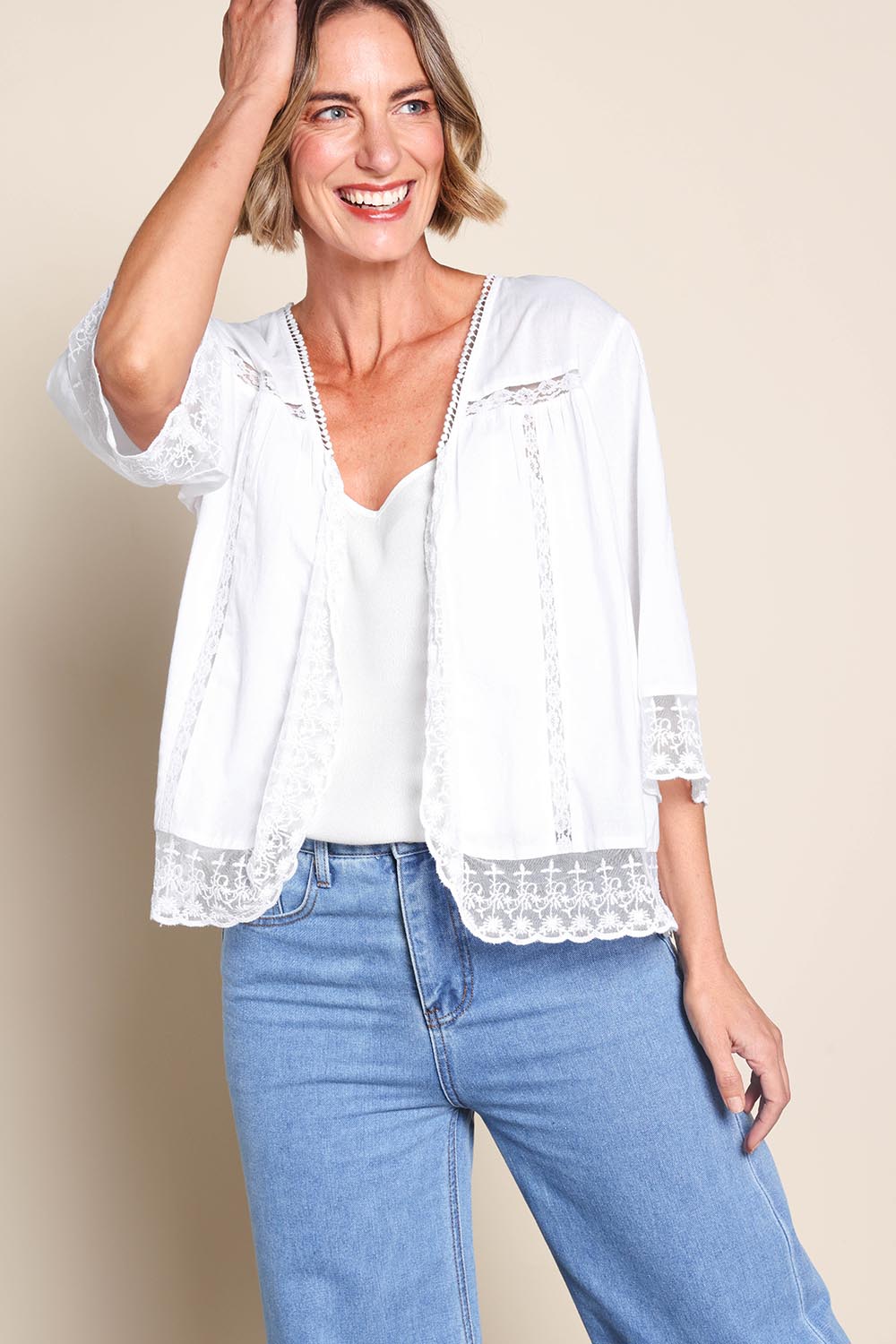 Model Riinar wearing size 10 of the Spring Day Cotton Throw - White in colour White, from an angle