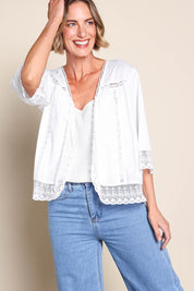 Model Riinar wearing size 10 of the Spring Day Cotton Throw - White in colour White, from an angle