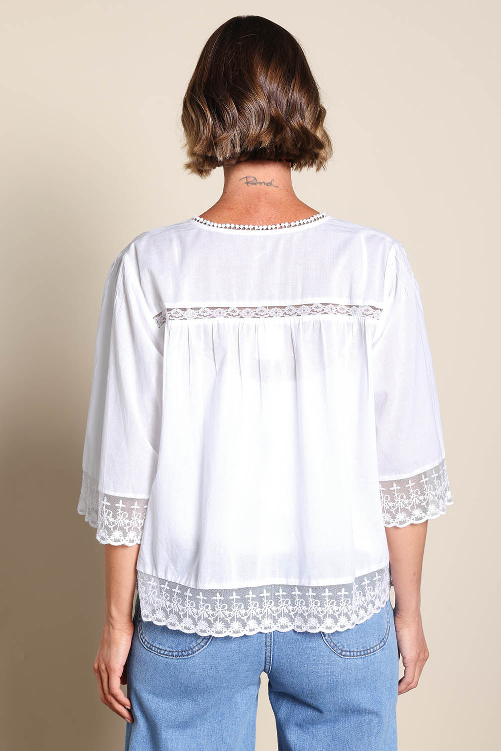 Model Riinar wearing size 10 of the Spring Day Cotton Throw - White in colour White, from the back