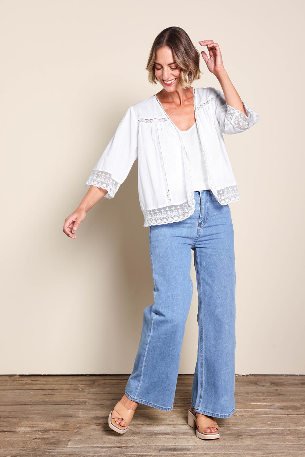 Model Riinar wearing size 10 of the Spring Day Cotton Throw - White in colour White, from the front