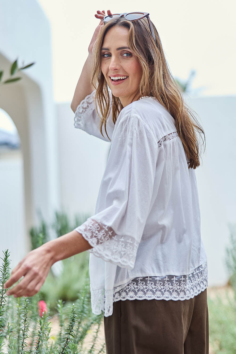 Model Tegand wearing size 10 of the Spring Day Cotton Throw - White in colour White, from an angle