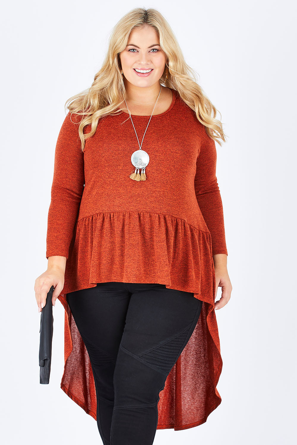 Model Sophie wearing size 18 of the Falling For You Tunic in colour Rust, from the front, cropped image