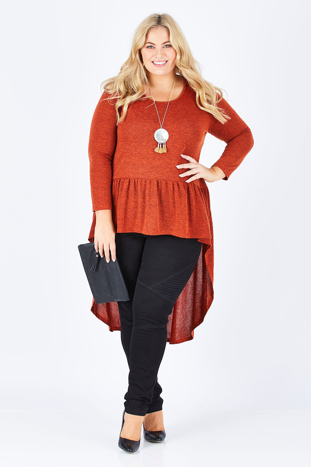 Model Sophie wearing size 18 of the Falling For You Tunic in colour Rust, from the front, showing the whole outfit
