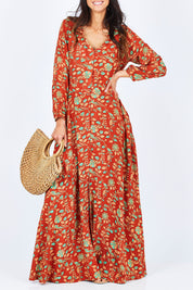 Model Gemma wearing size 10 of the Meet Under The Palm Tree Maxi in colour Earth, from the front, cropped image