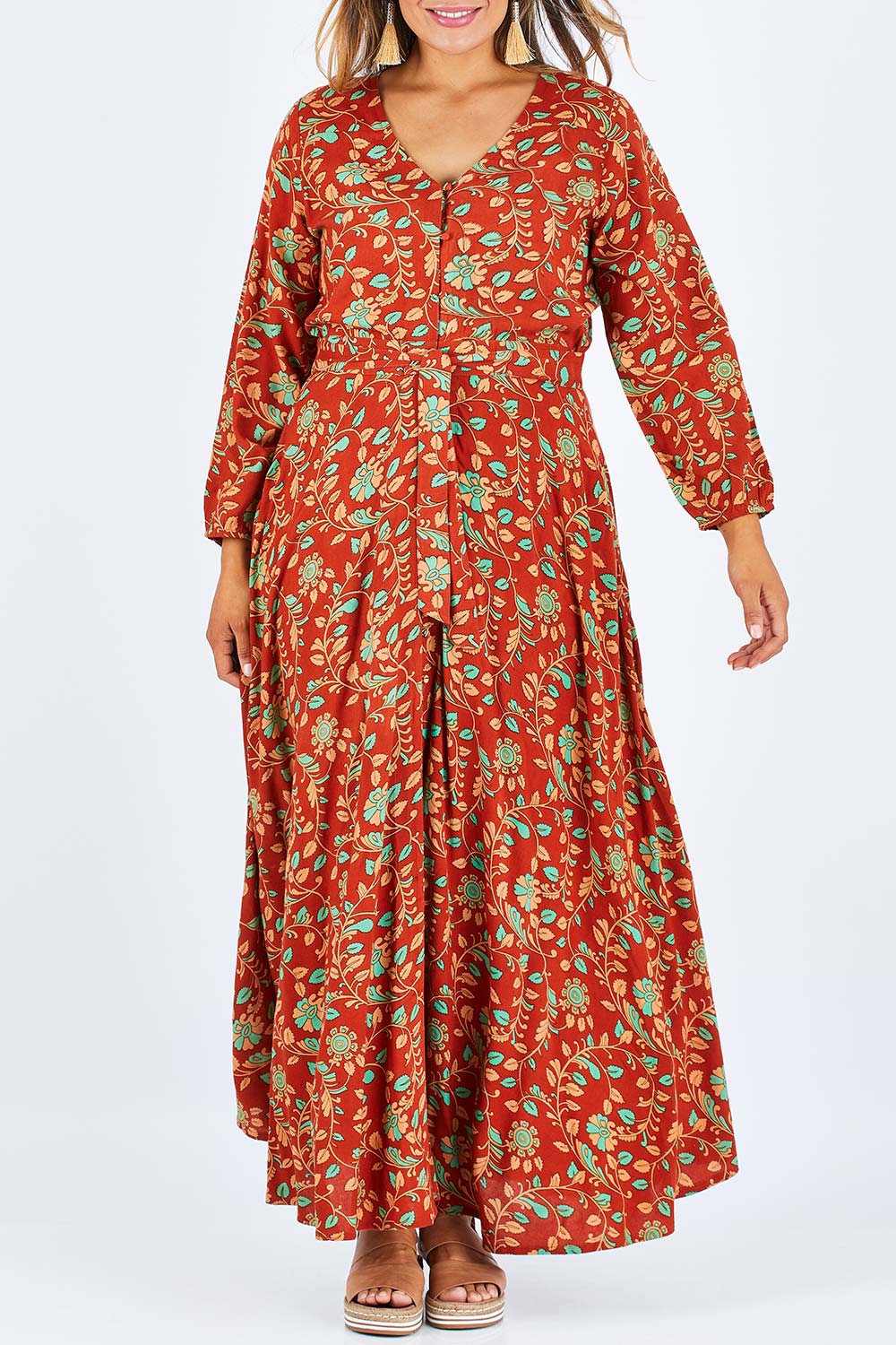 Model Palatina wearing size 14 of the Meet Under The Palm Tree Maxi in colour Earth, from the front, cropped image