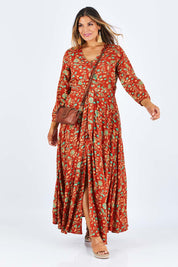 Model Palatina wearing size 14 of the Meet Under The Palm Tree Maxi in colour Earth, from the front, showing the whole outfit
