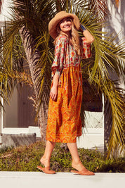 Model Marnee wearing size 10 of the You Are A Firecracker Dress in colour Firecrack, from the front, showing the whole outfit