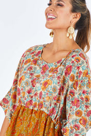 Model Palatina wearing size 14 of the You Are A Firecracker Dress in colour Firecrack, from the front, cropped image