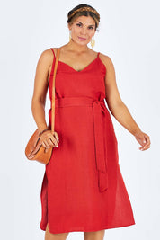 Model Palatina wearing size 14 of the Sunshine And Happiness Dress in colour Ketchup (Red), from the front, cropped image