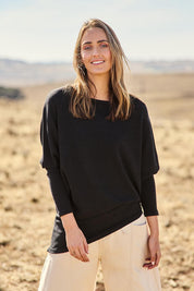 Model Nat wearing size 10 of the Snuggle Up Jumper in colour Black (Black), from the front, showing the whole outfit