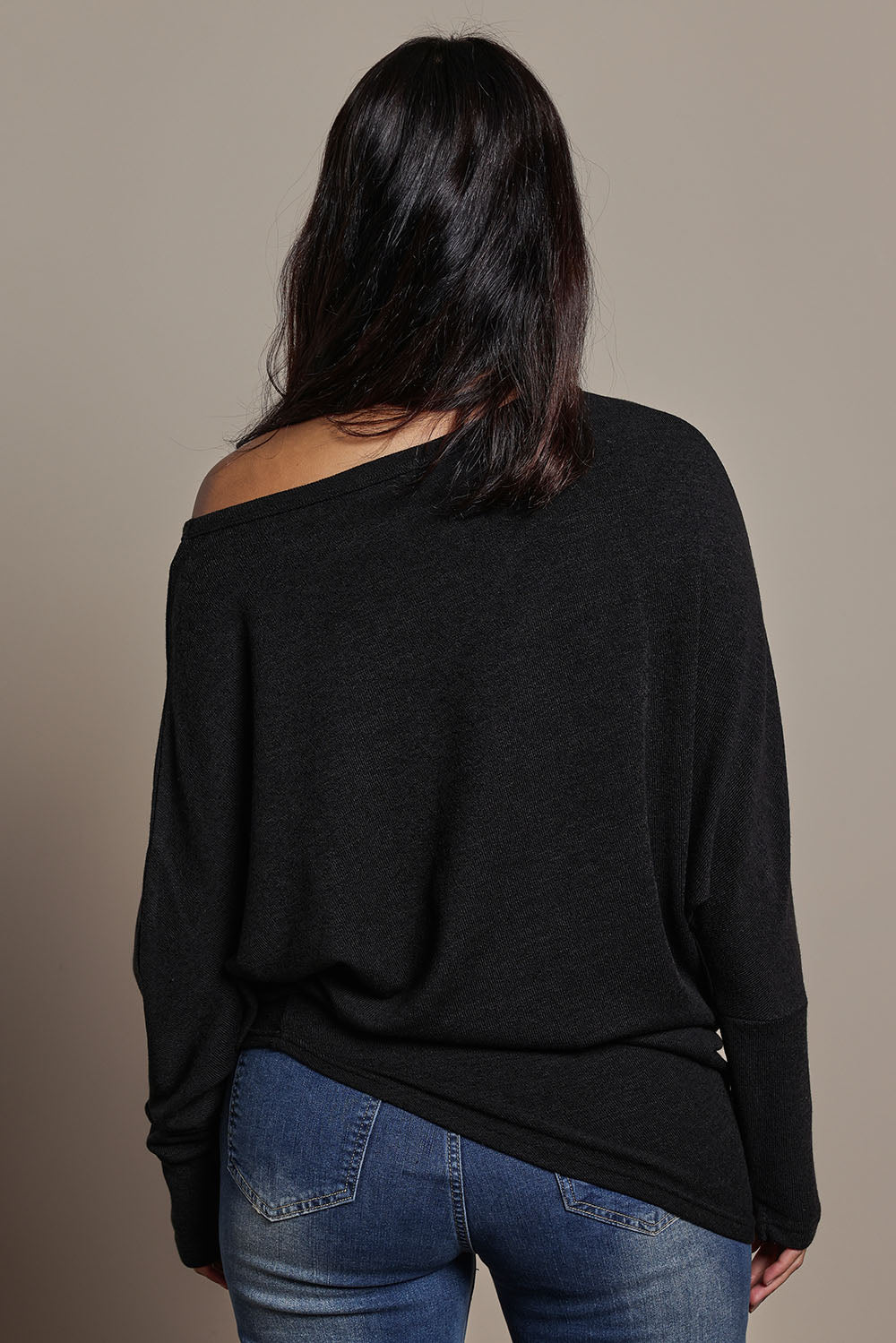Model Tahnee wearing size 10 of the Snuggle Up Jumper in colour Black (Black), from the back