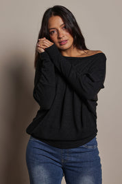 Model Tahnee wearing size 10 of the Snuggle Up Jumper in colour Black (Black), from the front, cropped image