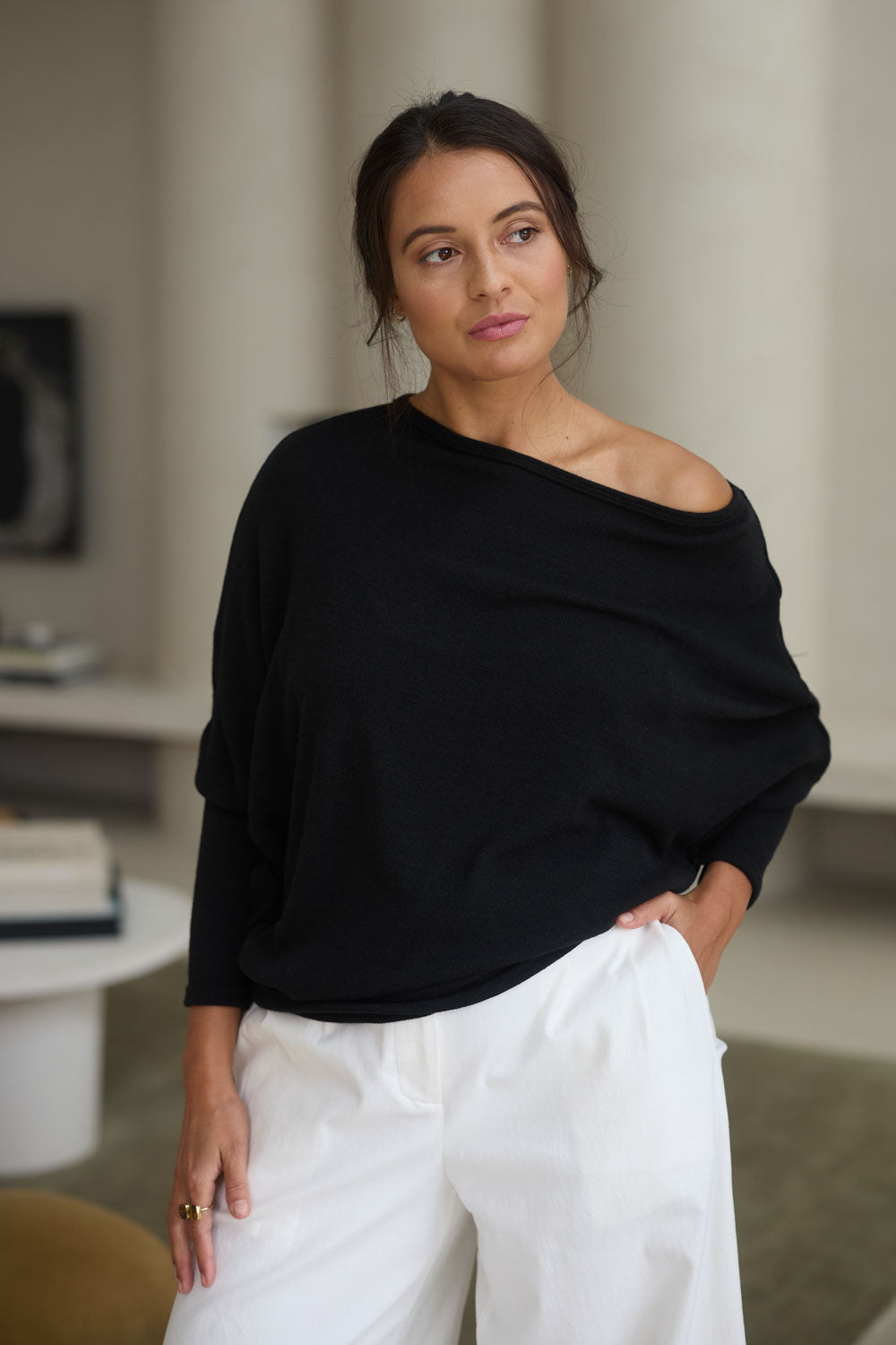 Model Tahnee wearing size 10 of the Snuggle Up Jumper in colour Black (Black), from the front, showing the whole outfit