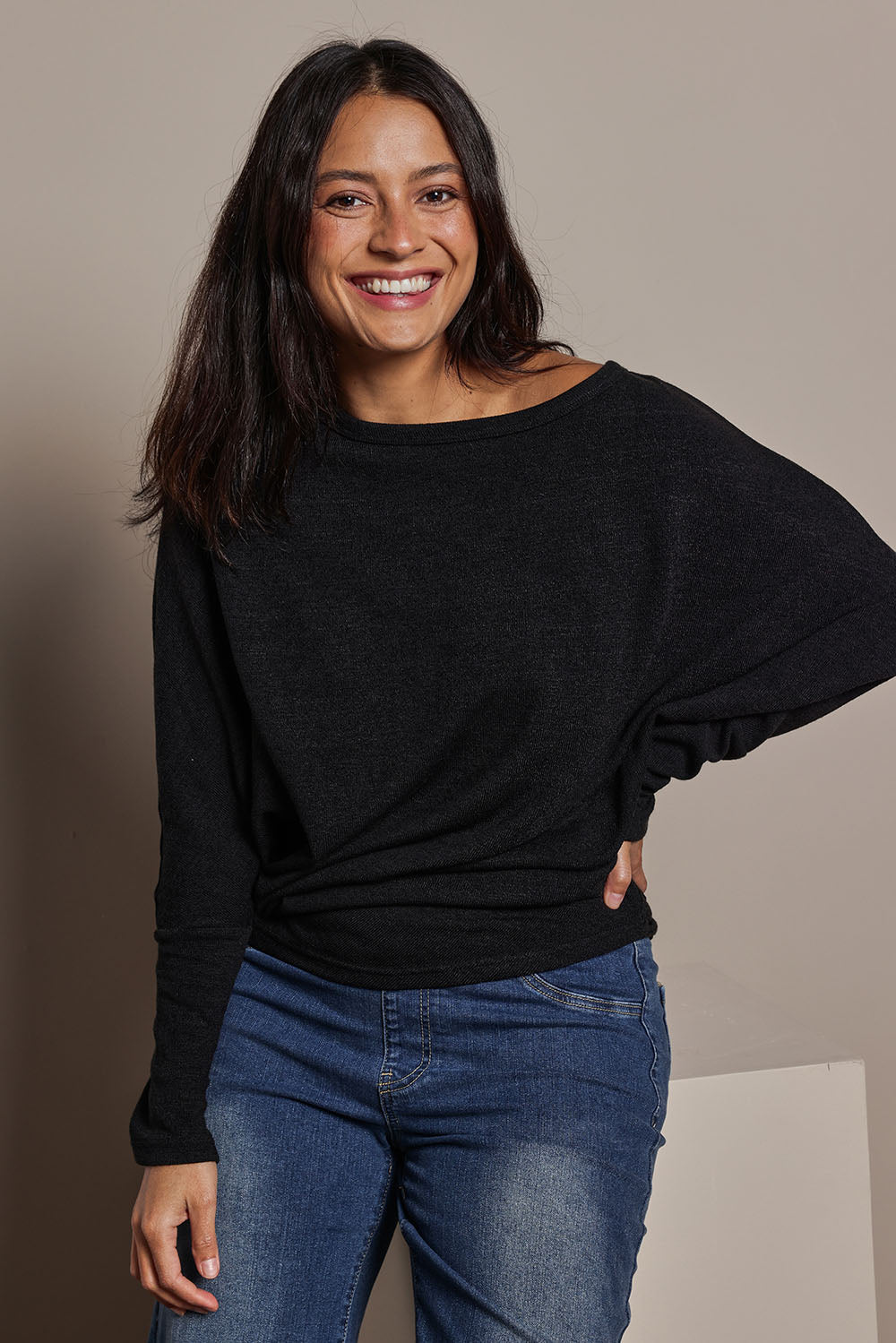 Model Tahnee wearing size 10 of the Snuggle Up Jumper in colour Black (Black), from the front, showing the whole outfit