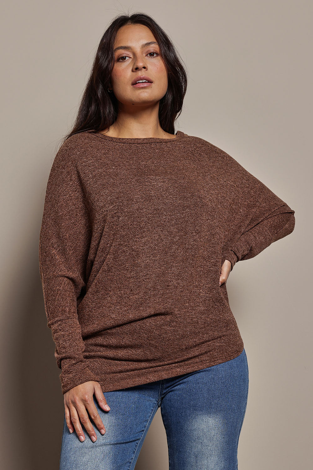 Model Tahnee wearing size 10 of the Snuggle Up Jumper in colour Chocolate, from the front, cropped image